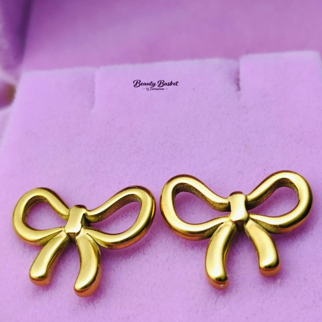 bow stud earrings stainless steel gold tone close view
