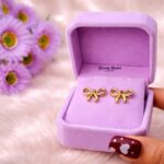 bow stud earrings stainless steel gold tone full view