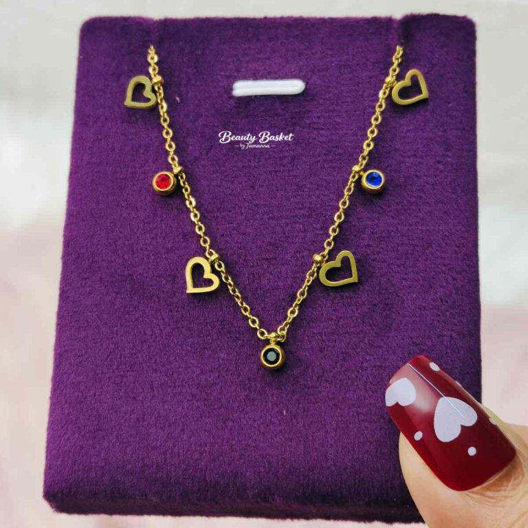 gold tone heart charm necklace with red blue stones full view