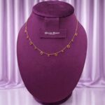 gold tone heart charm necklace with red blue stones full view