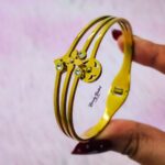 multi charm design bangle stainless steel gold tone close view